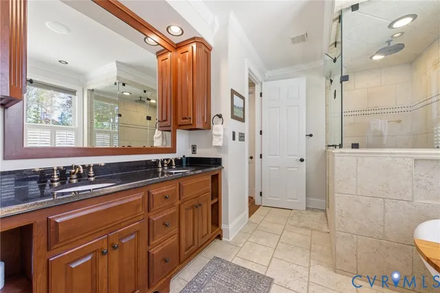 a spacious bathroom with a double vanity sink a mirror and a shower
