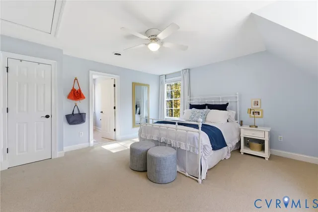 a spacious bedroom with a bed and a chandelier