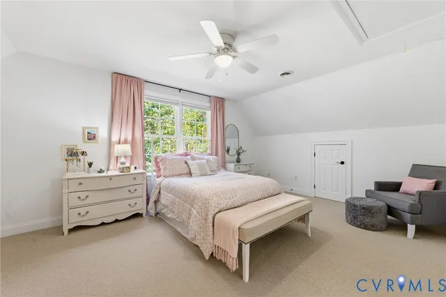 a spacious bedroom with a bed and a window