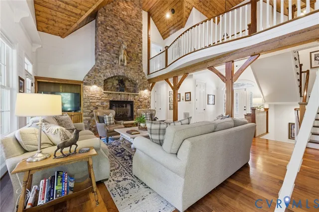 a living room with furniture a fireplace and a large window