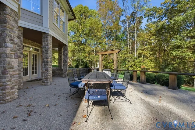 a view of a patio with table and chairs and potted plants