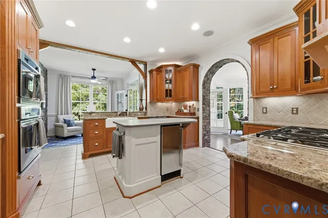a kitchen with stainless steel appliances granite countertop a stove a sink and a refrigerator