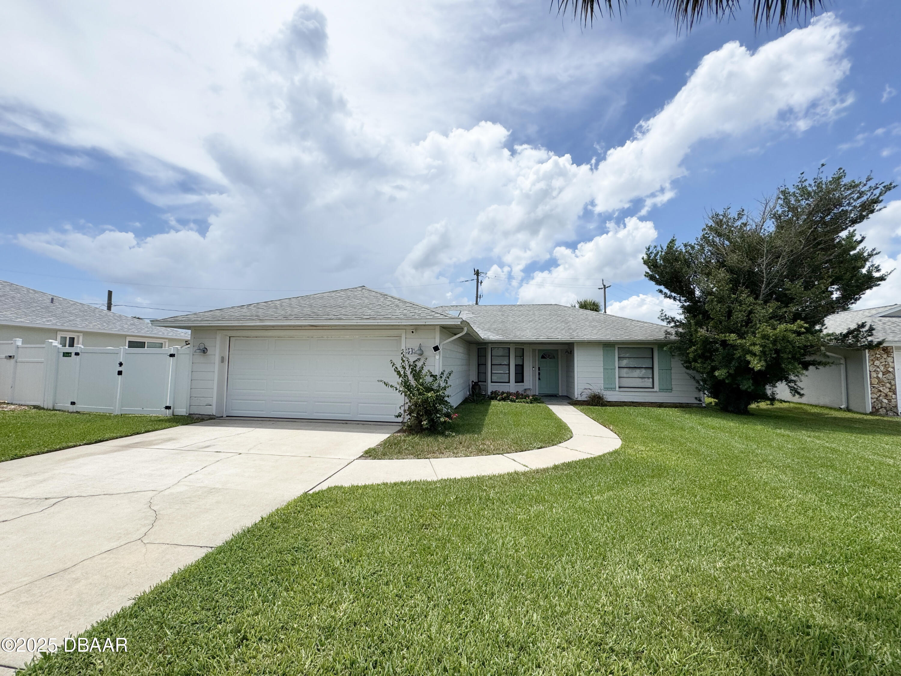 a front view of a house with a yard garage and outdoor seating