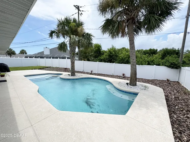 a view of a swimming pool with a yard