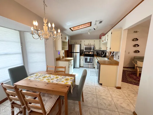 a view of a dining room with furniture and chandelier