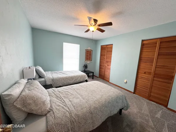a bedroom with bed and window