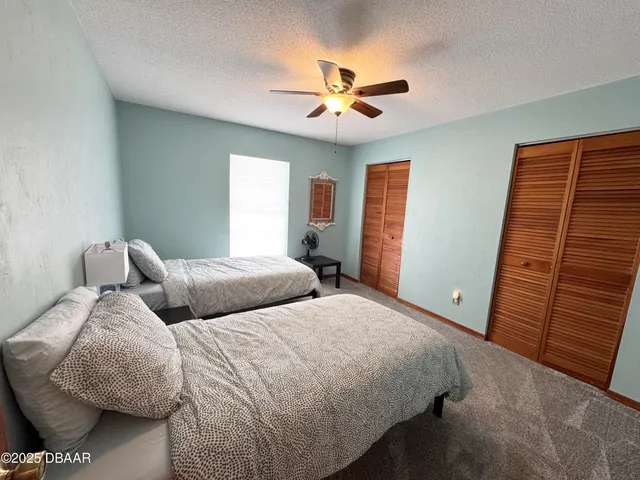 a bedroom with bed and window