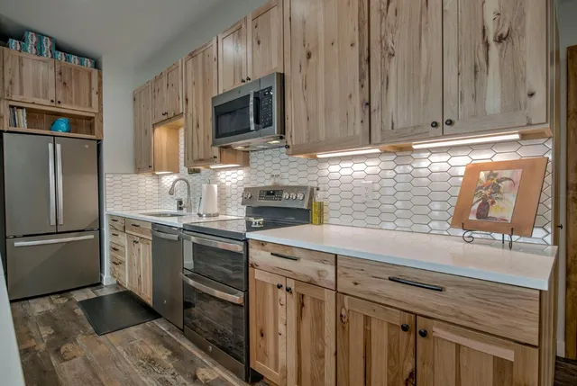 a kitchen with appliances cabinets and a sink