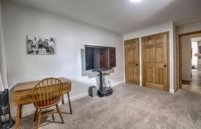 a bedroom with two beds and a desk