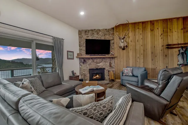 a living room with furniture a fireplace and a flat screen tv