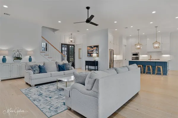 a living room with furniture and kitchen view