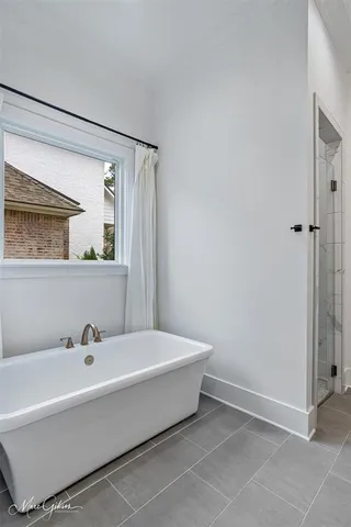 a spacious bathroom with a bathtub and a sink