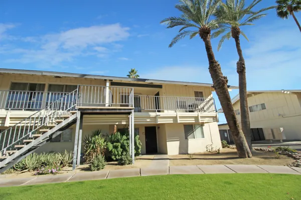 a view of a house with many windows and a yard