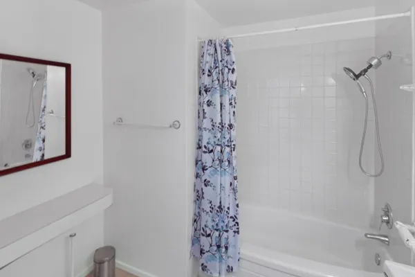 a bathroom with a bathtub and shower