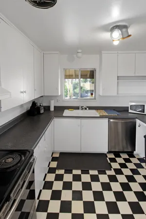 a kitchen with a sink a stove and a cabinets