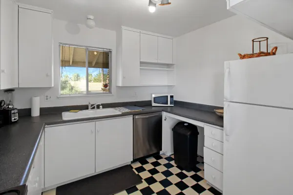 a kitchen with a refrigerator and a sink