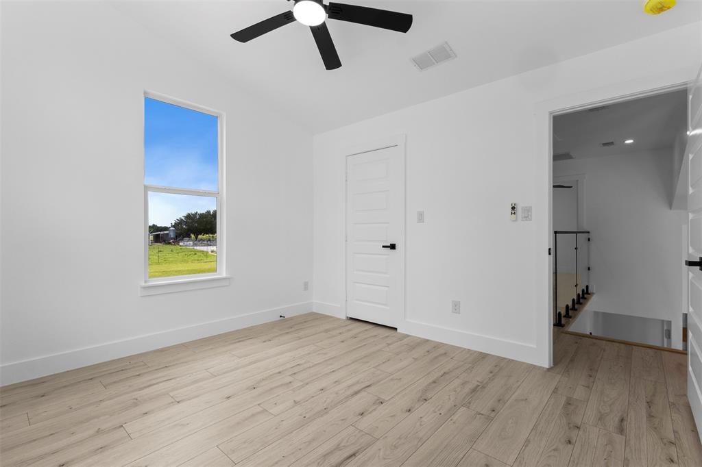 180 County Road 2245 Emory, TX 75440 - Photo 24 of 34 an empty room with wooden floor and window