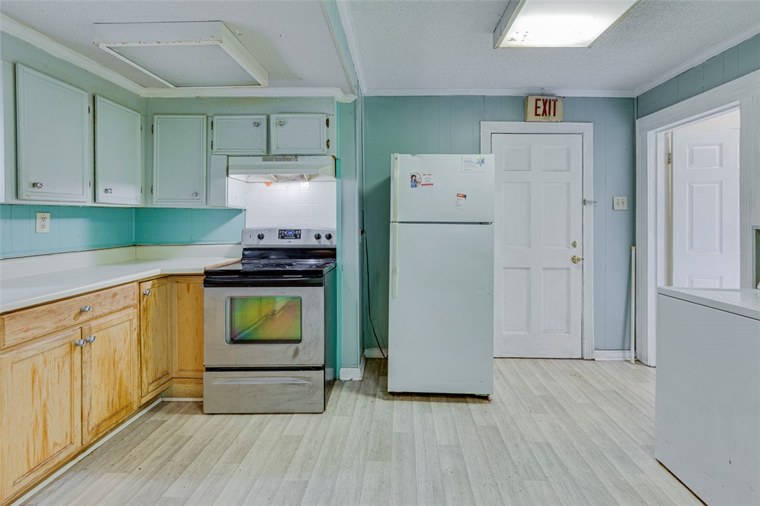 301 Cater Street Anderson, SC 29621 - Photo 18 of 29 Functional kitchen design features classic wood cabinetry paired with durable vinyl flooring throughout.