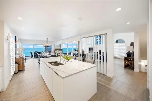 a kitchen that has a lot of cabinets a sink and wooden floor