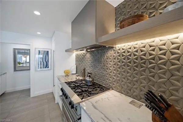 a stove top oven sitting inside of a kitchen