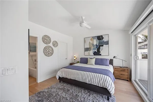 a bedroom with a bed and a painting on the wall