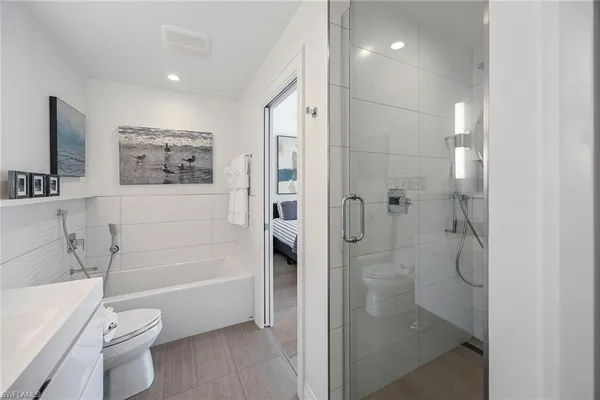 a bathroom with a toilet a sink and bathtub