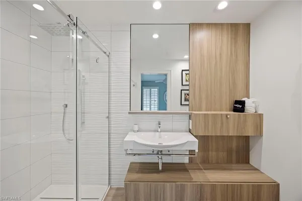 a bathroom with a sink a toilet and shower