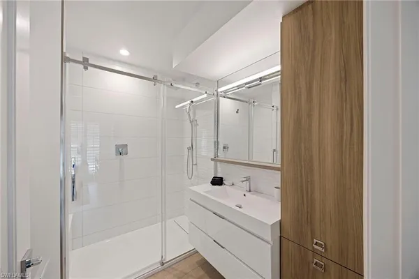 a bathroom with a shower sink and mirror