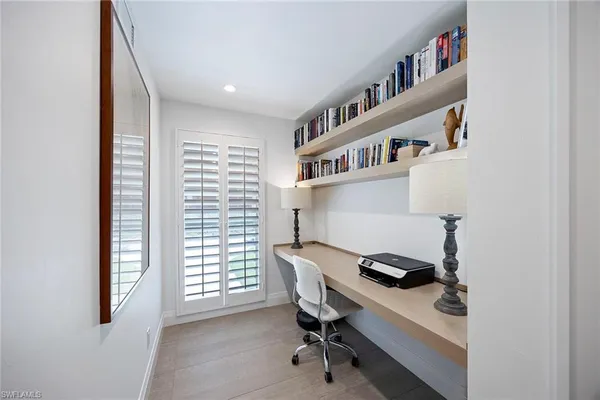 a workspace with a window and a chair