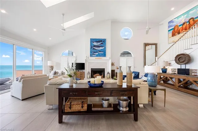 a living room with fireplace furniture and a large window