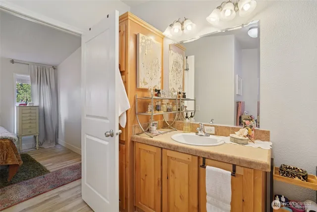 a bathroom with a sink vanity granite and a mirror