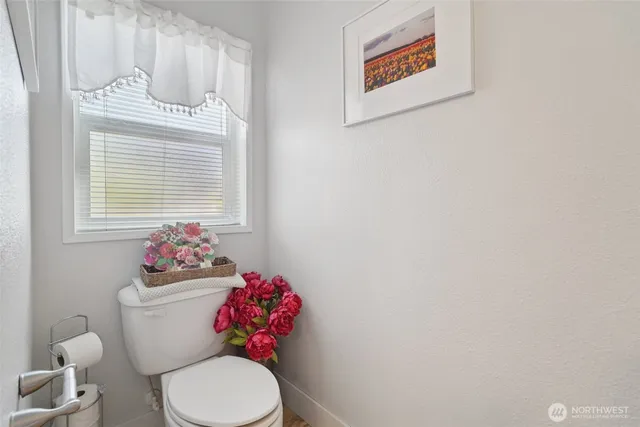 a bathroom with a toilet a sink and a mirror