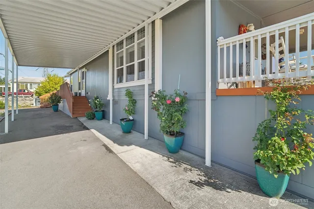 a front view of a house with sitting area and garden
