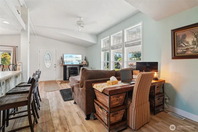 a living room with furniture a flat screen tv and a window