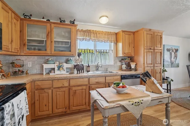 a kitchen with a sink stove and cabinets
