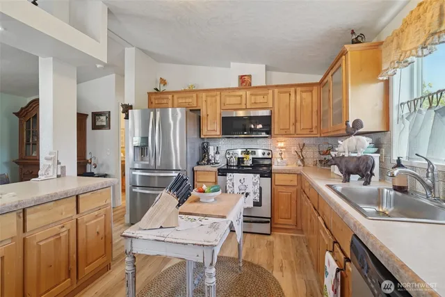 a kitchen with refrigerator cabinets and a sink