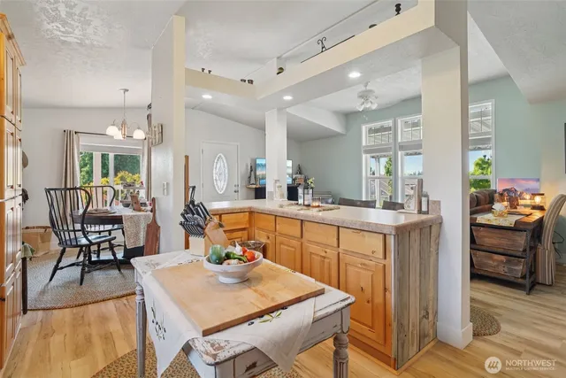 a large kitchen with kitchen island a dining table and chairs