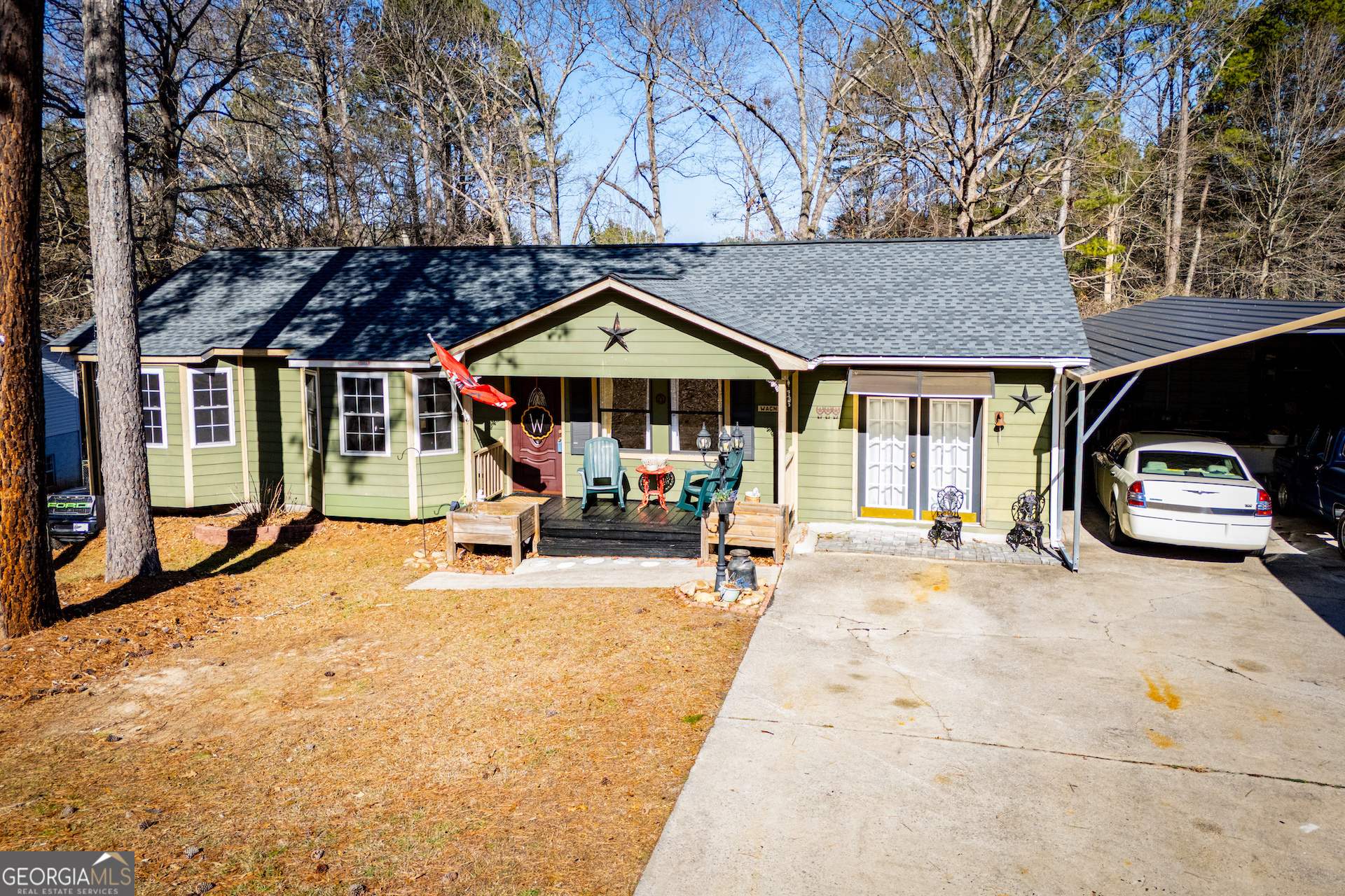 162 Parkway Circle Villa Rica, GA 30180 - Photo 3 of 35 a view of a patio with table and chairs under an umbrella