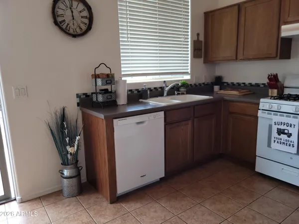 a kitchen with stainless steel appliances granite countertop a sink and a stove