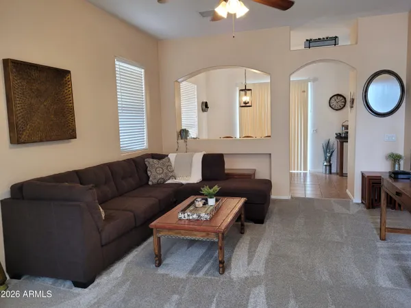 a living room with furniture a large window and a fireplace