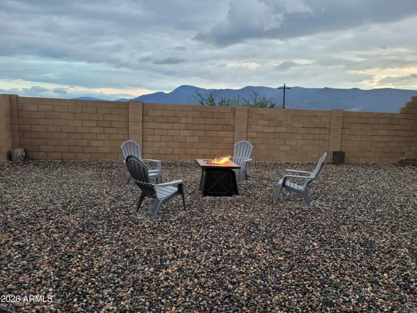 a lawn chairs sitting in a backyard with chair
