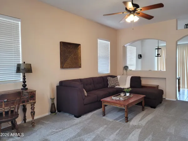 a living room with furniture and a mirror