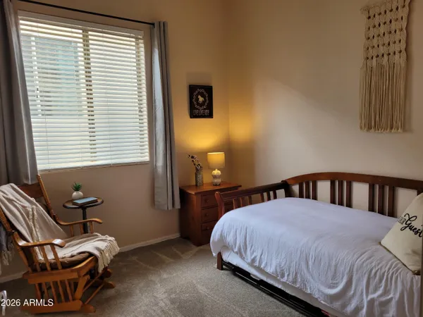 a bedroom with a bed and chair