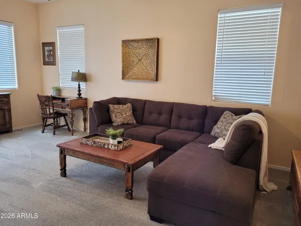 a living room with furniture lamp and window