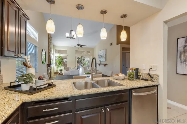 a bathroom with a granite countertop double vanity sink and a mirror