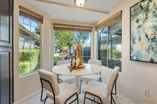 a view of a dining room with furniture large windows and wooden floor