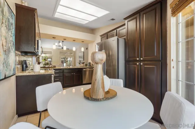 a view of a dining room with furniture a chandelier and wooden floor