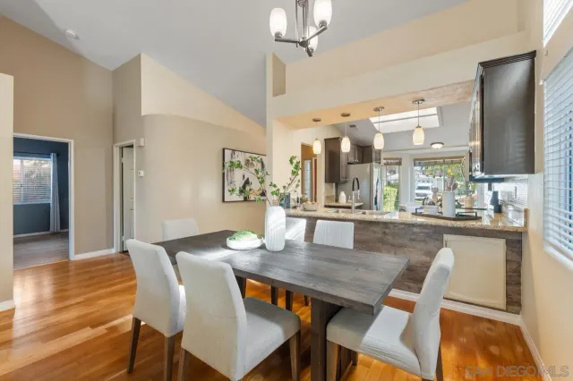 a dining room with furniture and wooden floor