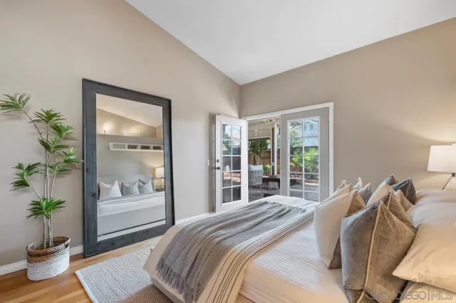 a bedroom with a bed and a large window