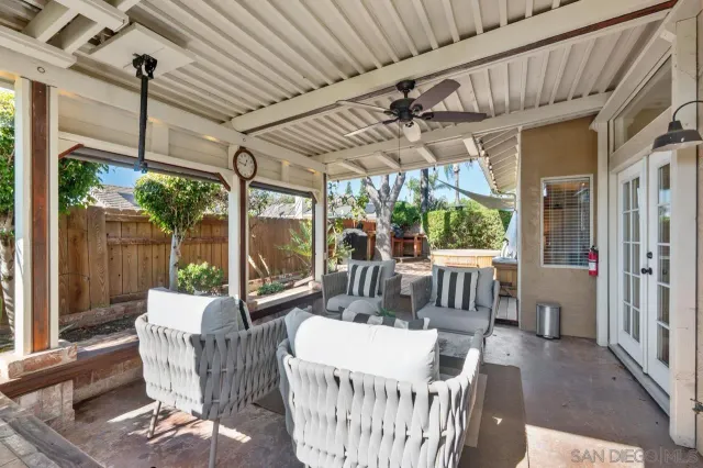 a view of a patio with a table chairs and a large umbrella